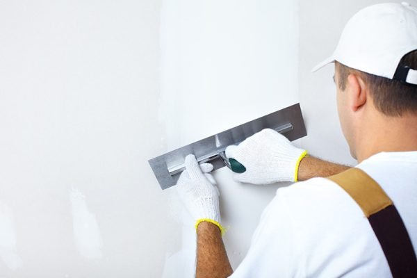 Mature contractor  plasterer working indoors